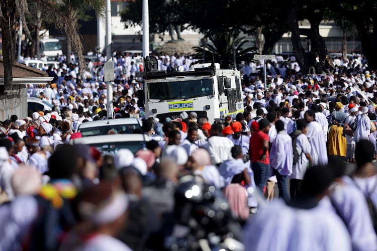 Police monitor the thousands of worshippers.