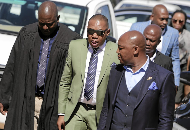 WOMEN BEATER Former higher education deputy minister Mduduzi Manana, centre, enters the Randburg Magistrate's Court in Johannesburg for sentencing. Manana was convicted of three charges of assault with intent to do grievous bodily harm.