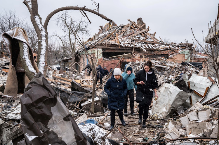 Women walk among remains of buildings destroyed by shelling, as Russia's invasion of Ukraine continues, in Zhytomyr, Ukraine, March 2 2022. Pictue: VIACHESLAV RATYNSKYI/REUTERS