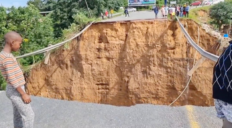 A large portion of Ntuzuma Road, north or Durban, has been washed and formed a massive sinkhole. Residents claim a minibus taxi and another vehicle were swept away due to the force of water following torrential rains.