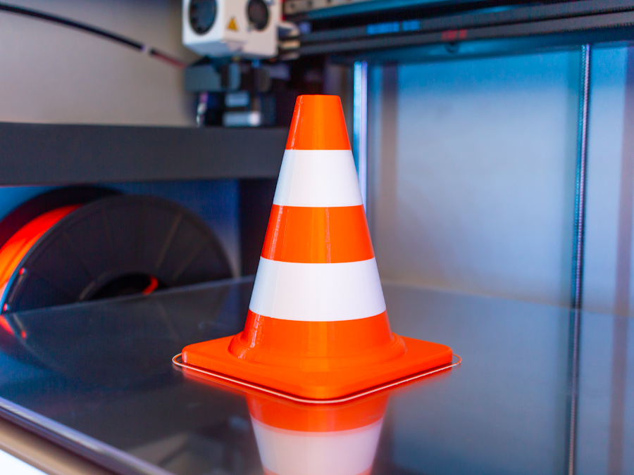 A dual extruded traffic cone without any smearing or mixing or colors from the carefully calibrated extruders.