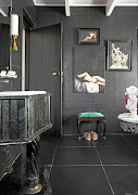 The basin pedestal in the bathroom is made of green Argentine marble, which was bought  on auction. The large nude is one of Jan-Georg's paintings.