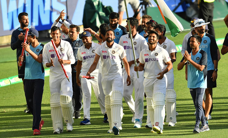 India celebrates winning on day five of the fourth test match between Australia and India at the Gabba in Brisbane