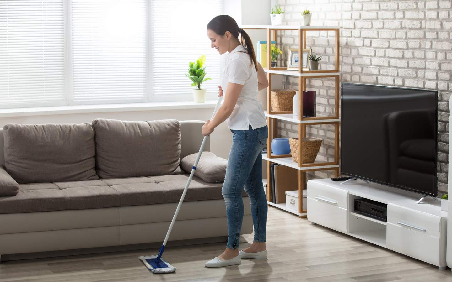 woman cleaning living room