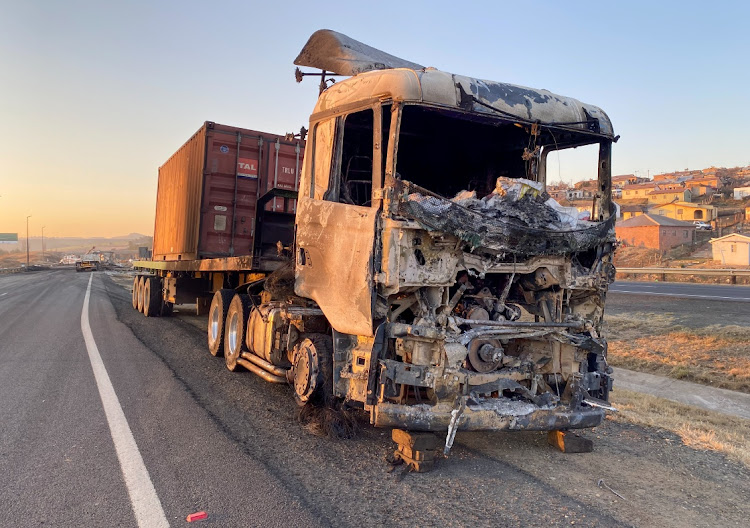 A burnt out truck lies beside the road following protests linked by police to former president Jacob Zuma's imprisonment, in Mooi River on July 10 2021. Picture: REUTERS/SIYABONGA SISHI