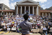 A #FeesMustFall protester addresses thousands of UCT students and staff who want the institution to reopen on Monday.