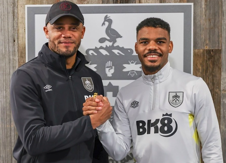 Burnley FC manager Vincent Kompany (L) with new signing Lyle Foster.