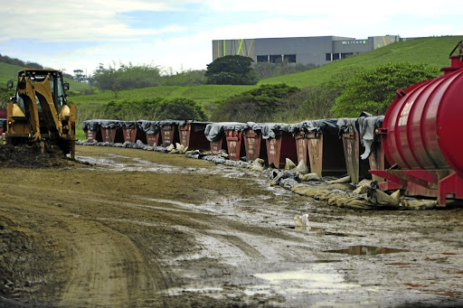 Dozens of skips line the banks of the Ohlanga River, storing hazardous waste that leaked out of UPL's chemical warehouse in Cornubia, north of Durban, which was torched during the unrest in July.