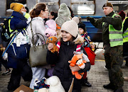 A girl clutches her toys as a Ukrainian train transporting hundreds of people fleeing from the Russian invasion of Ukraine arrives in Przemysl, Poland. Picture: REUTERS/YARA NARDI