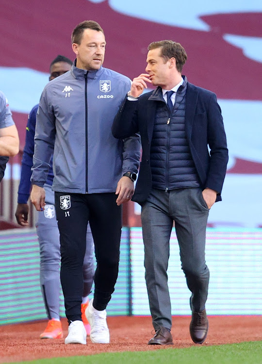 Fulham manager Scott Parker speaks with Aston Villa assistant manager John Terry before the match