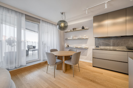 Dining area with adjacent modern kitchen in this luxury apartment / penthouse for sale in Prague ($899,197 - 88 m²)