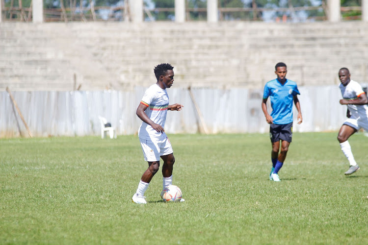 Uganda's Travis Mutyaba (in white) in action against Zanzibar during their pool B match at the Bukhungu stadium in Kakamega County on Wednesday. Uganda won 2-1