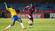 Swallows defender Mbulelo Lukhubeni challenges for the ball with Neo Maema of Mamelodi Sundowns during their DStv Premiership match at Loftus Versfeld Stadium in Pretoria on January 3.