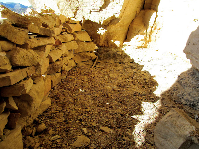 Dry-laid masonry wall and fill behind it