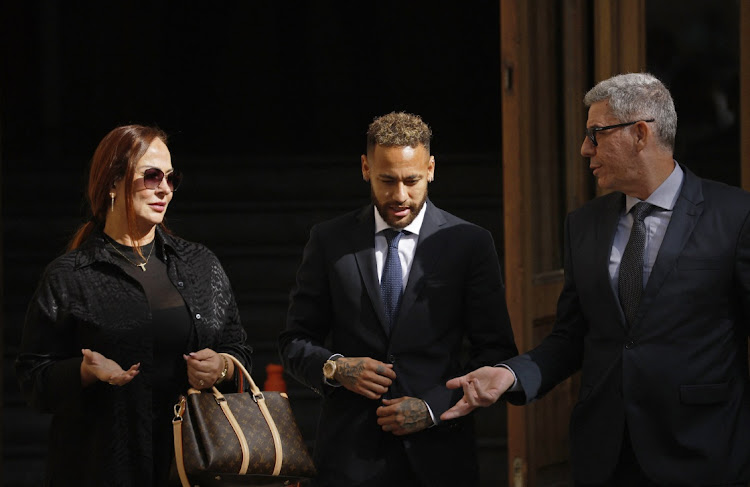 Brazil's Neymar, centre, leaves court in Barcelona, Spain, with his mother, Nadine Goncalves, and a member of his lawyer team on October 18 2022 after standing trial on fraud and corruption charges over the transfer to FC Barcelona from Santos in 2013. Picture: REUTERS/ALBERT GEA