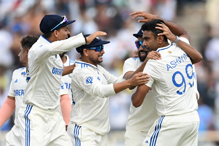 Ravichandran Ashwin of India celebrates with teammates after dismissing Joe Root of England on day three of the fourth Test at JSCA International Stadium Complex in Ranchi, India on Sunday.