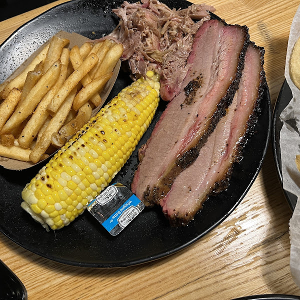 Pulled pork and brisket, with a side of corn and french fries