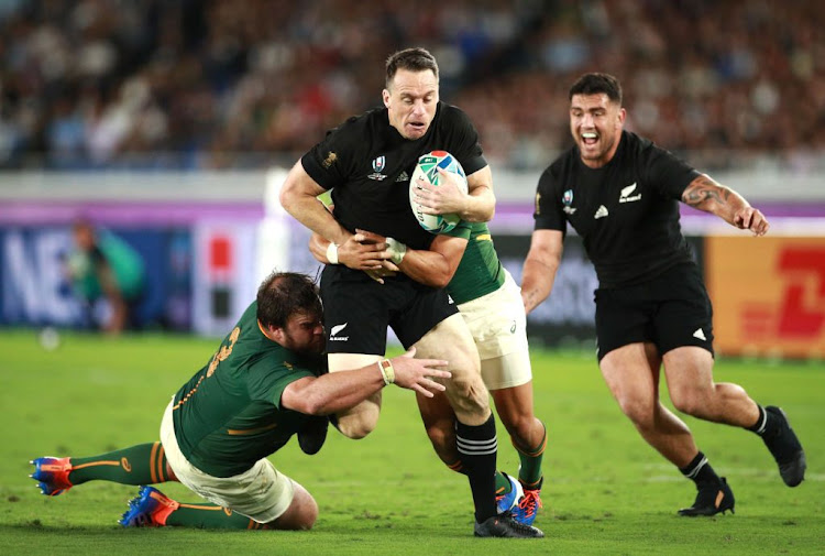 Ben Smith of New Zealand is tackled during the Rugby World Cup 2019 Group B game between New Zealand and South Africa at International Stadium Yokohama on September 21, 2019 in Yokohama, Kanagawa, Japan.