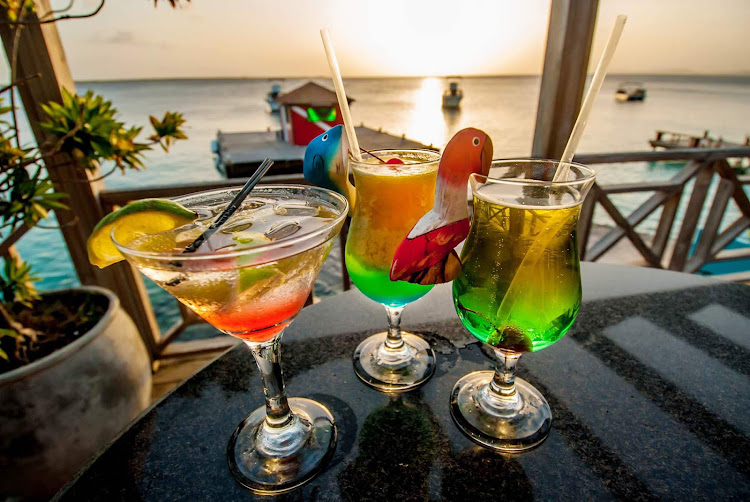 Watch the sun set with a tropical drink in Bonaire. 