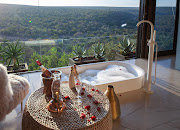 A sunken bath in a Noka Camp villa with a view of the Palala River below. 