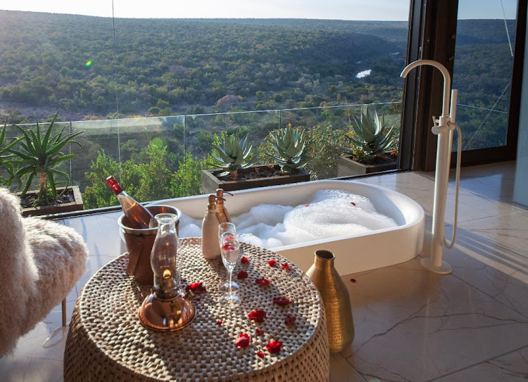 A sunken bath in a Noka Camp villa with a view of the Palala River below.