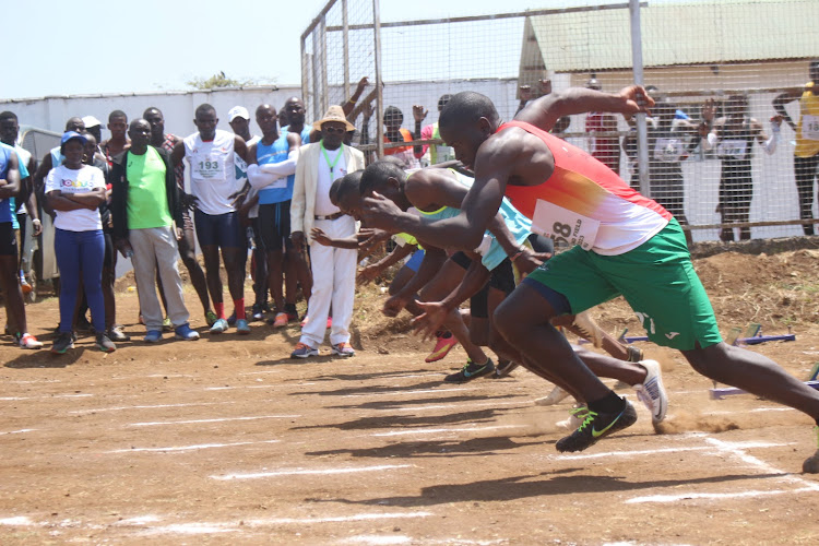 Athletes take off in the men's 100m heats