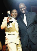 JUBILANT: Andrew Molefe, who was honoured with a Maftown golden Stars award, and MC Rantebeng Makapan. 26/09/07. © Sowetan.