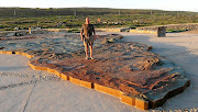 Lars Ingildsen, a Dane who lives in the US, stands atop the new Map of Africa Monument in the Agulhas National Park, at the southern tip of Africa.   