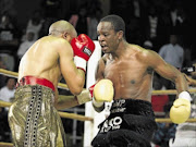 ON COMEBACK TRAIL:
       Phillip Ndou, right,  forces  Pius Dipheko to cover up during their energy-sapping fight, which Ndou won via a fifth-round stoppage at Nasrec Arena in  June. Ndou steps into the ring in Namibia on Saturday    
      Photo: N-Squared