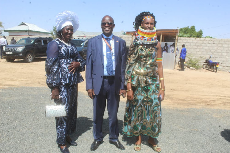 Turkana Governor-elect Jeremiah Lomurkai poses in photo with his two wives ready for the swearing in ceremony at Ekaales centre in Lodwar on Thursday, August 25,2022.