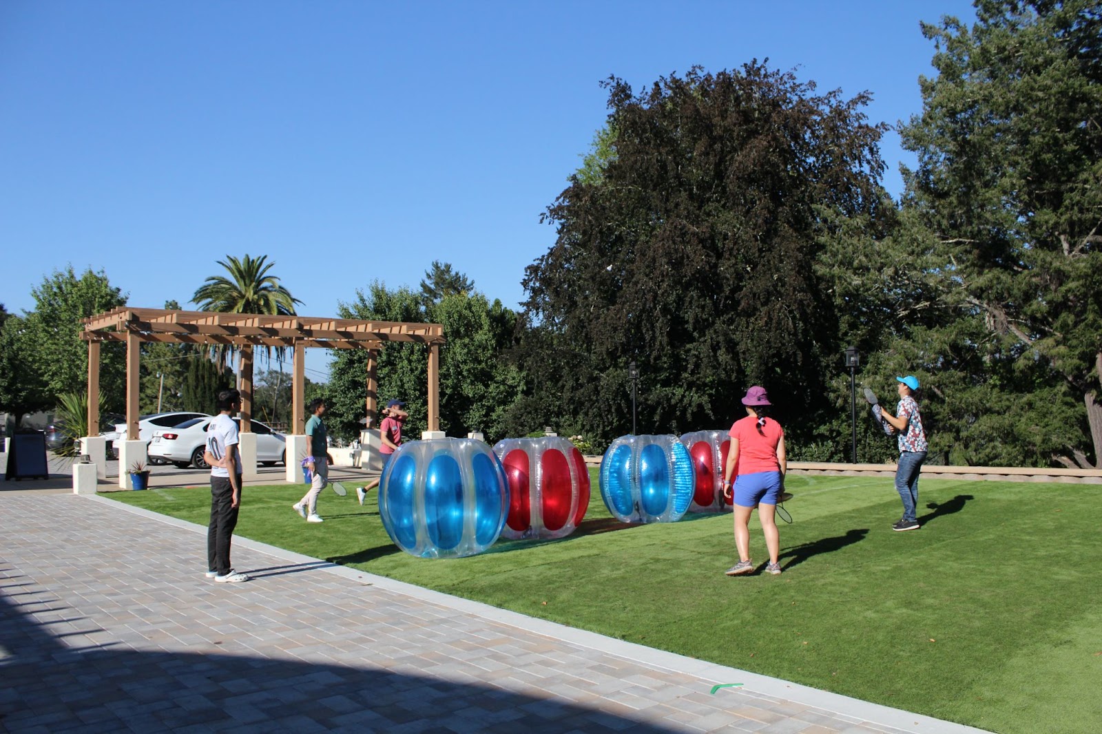 Residents at the retreat are playing badminton. The net has been replaced by bumper balls.