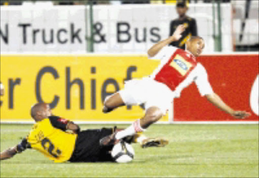 CLASH OF EQUALS: Kaizer Chiefs defender Jimmy Tau tackles Ajax Cpae Town's Granwald Scott in their Premiership clash at Loftus Stadium in Pretoria on Saturday night. Pic. Chris Ricco. 27/09/08. © Backpagepix.