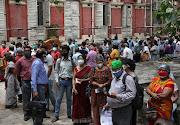 People wearing protective face masks wait to receive their second dose of COVISHIELD, a coronavirus disease (Covid-19) vaccine manufactured by Serum Institute of India, outside a vaccination centre in Kolkata, India, May 12, 2021. 