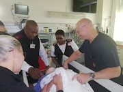 Prof Andrew Nicol, head of trauma at Groote Schuur Hospital, attends to a patient.