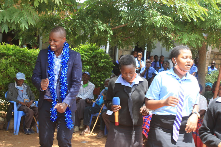 Mwingi West MP Charles Nguna dances with students of Kakululo Secondary School on February 19, 2021