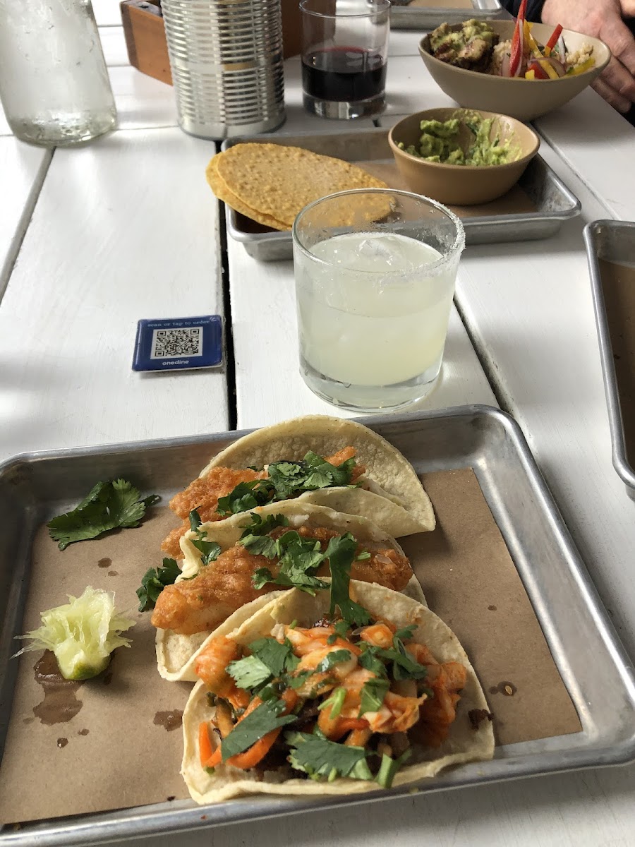 Steak taco topped w kimchi, fish tacos, margarita, chips and guac. Also red wine and a chicken rice bowl (also gluten free). All delicious!