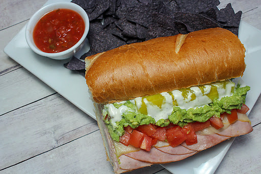 Rocky mountain oven toasted sub cut in half with tortilla chips and salsa.