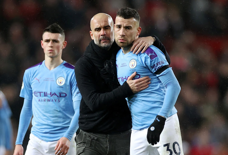 Manchester City manager Pep Guardiola with Nicolas Otamendi