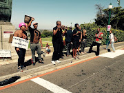 Student activist Chumani Maxwele, with his shirt off, during the Fees Must Fall protests at UCT. 