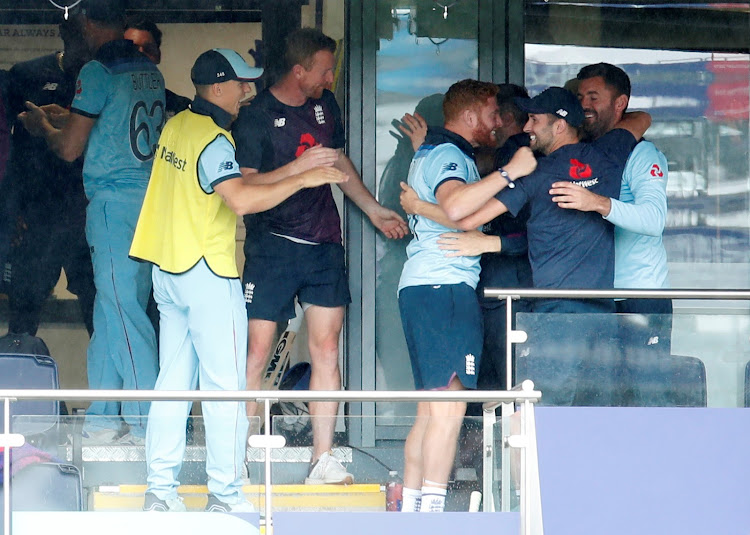 England's Jonny Bairstow and Mark Wood celebrate after the match.