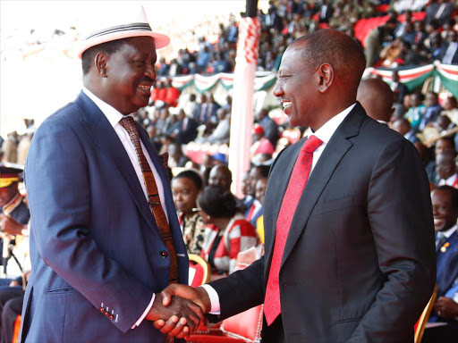 Former PM Raila Odinga in a jovial moment with DP WIlliam Ruto when he arrived for this year's Jamuhuri day celebrations at Nyayo Stadium in Nairobi.Pic\Charles Kimani\DPPS