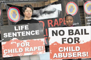 Women and Men Against Child Abuse protest outside court. 
