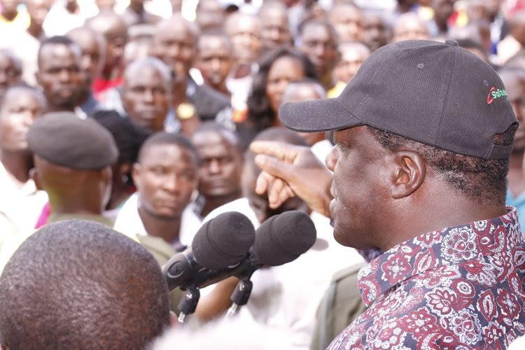 Kakamega governor Wycliffe Oparanya addressing Kakamega residents in Kakamega town after leading demolition of kiosks in the town on Thursday.