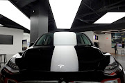 A Tesla Model Y is displayed in a showroom at the Miami Design District in Miami, Florida. The company's valuation hovers around $1.02-trillion (roughly R15,141,318,600,000). 