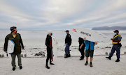 Surfers gather on a beach in Muizenberg to protest against lockdown restrictions. 