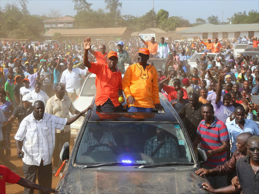 Cord leader Raila Odinga and aspiring MP Baraka Mtengo arrive for a campaign rally in Malindi ahead of the by-election set for March 7. Photo/ALPHONCE GARI