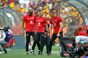 Orlando Pirates head coach Milutin Sredojevic (R) reacts on the bench alongside his assistants Rulani Mokwena (L) and Fadlu Davids (C) during an Absa Premiership match.