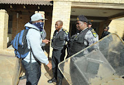 Cape Peninsula University of Technology students confront security personnel during the #FeesMustFall protests in 2016. File Photo.