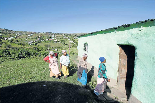 DEATH TRAP: Villagers enter the house where a young boy was slaughtered by his uncle at KwaNtsila Village near Port St Johns.