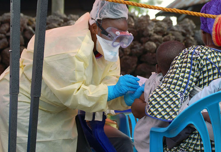 A child receives a vaccine against Ebola from a nurse in Goma on August 7 2019. Picture: AFP/AUGUSTIN WAMENYA